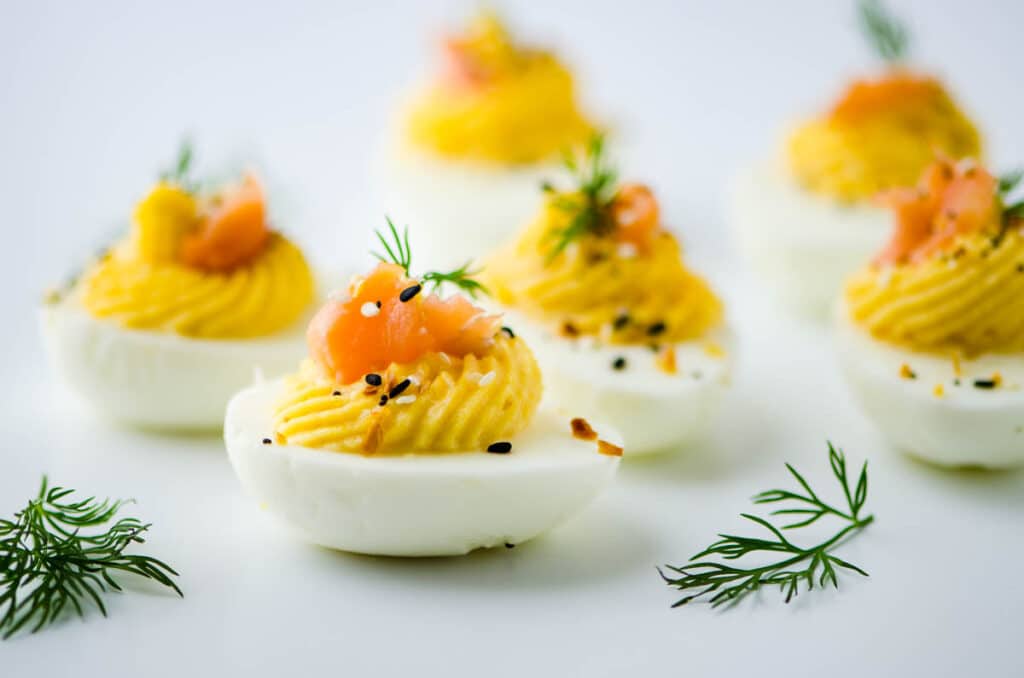 a platter of garnished smoked salmon deviled eggs.