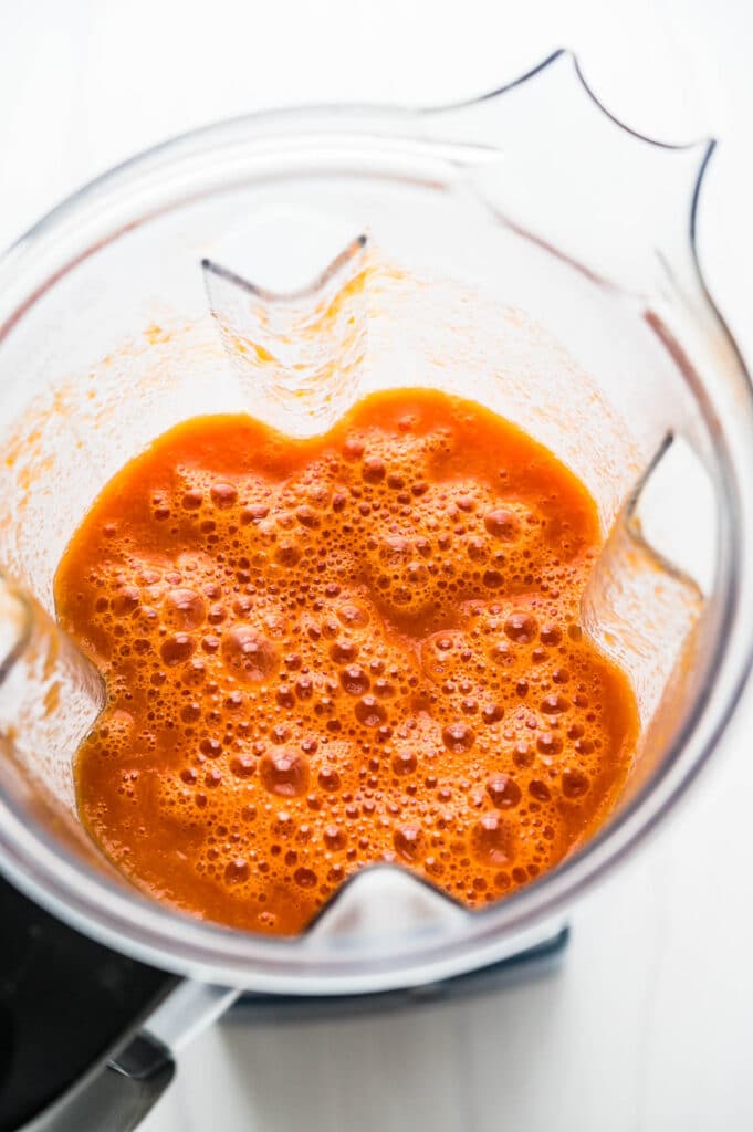 blending the tomato soup to make it creamy and smooth.