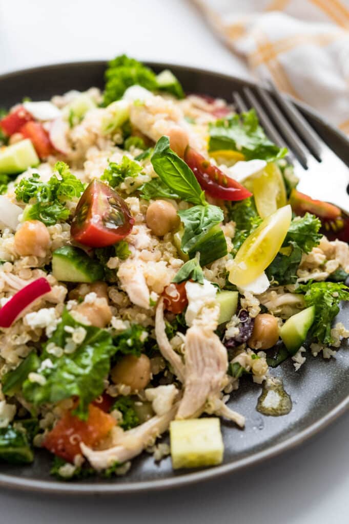 a serving of chicken kale and quinoa salad on a plate.