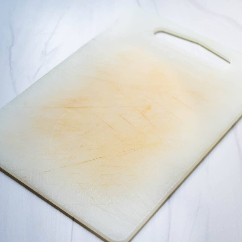 a stained, worn plastic cutting board.