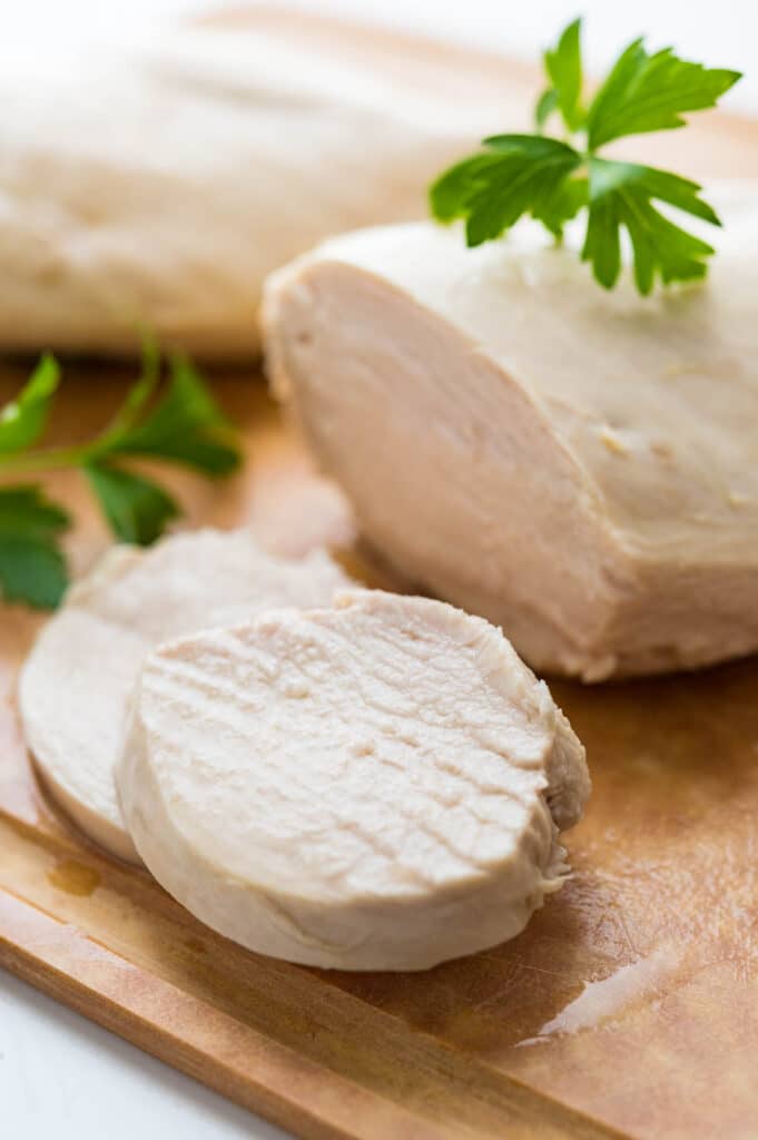 a closeup to show how juicy the poached chicken breasts are.