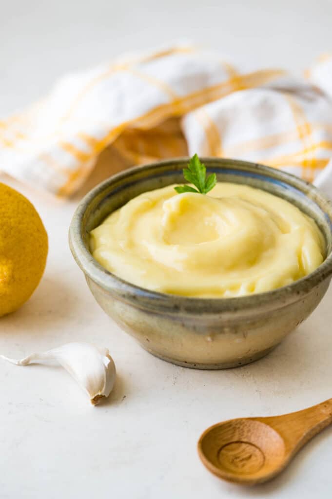 aioli in a small bowl with a wooden spoon.