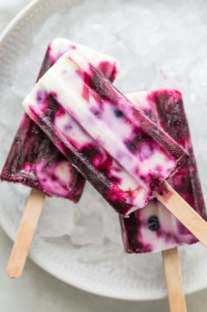 a bowl of yogurt swirl popsicles in a bowl with ice.