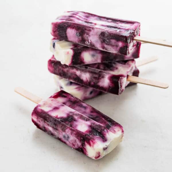 blueberry yogurt popsicles in a stack.