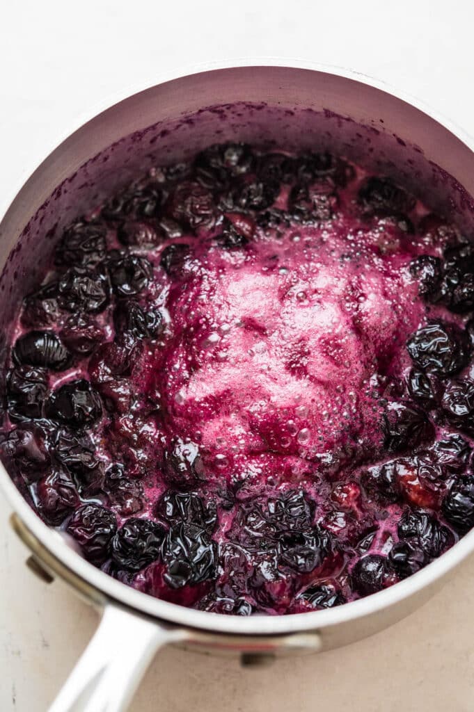 cooking the soft, purple compote.