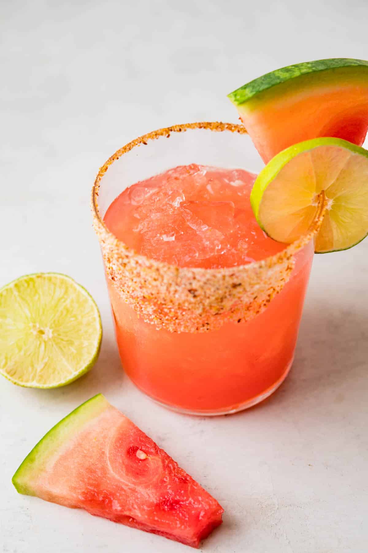 a watermelon margarita with melon and lime garnish.
