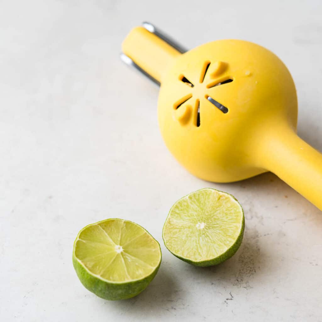 Squeezing limes for their juice.