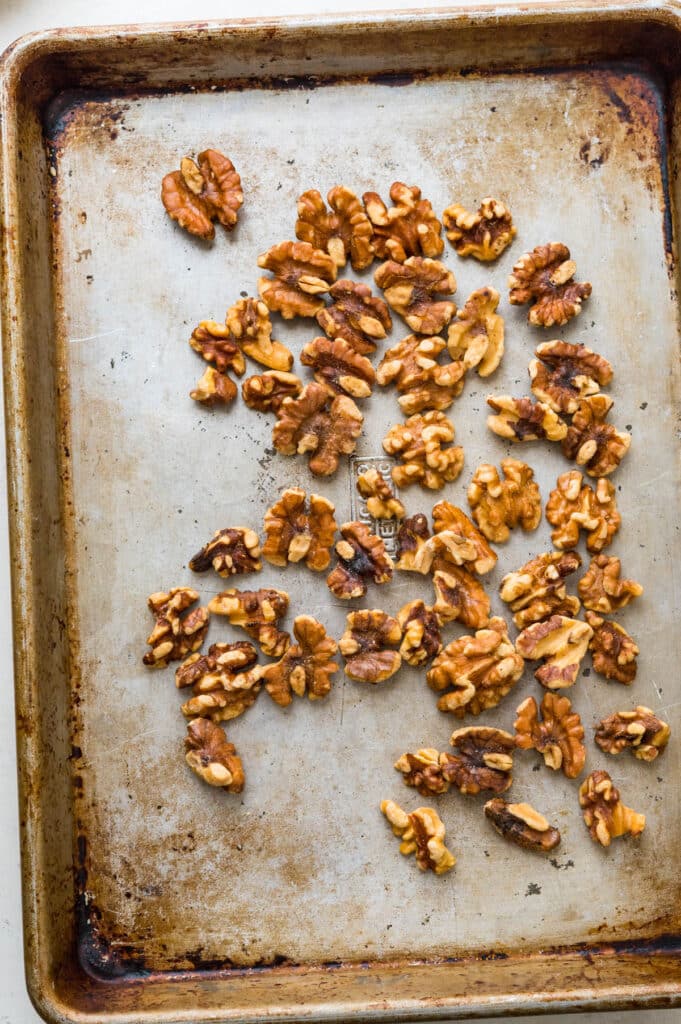 toasting walnuts on a sheet pan.