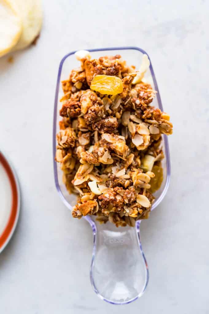 a scoop of granola clusters with dried apple, golden raisins and crunchy walnuts. 