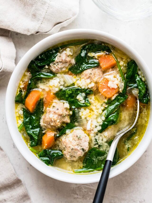 italian wedding soup in a bowl with spoon.