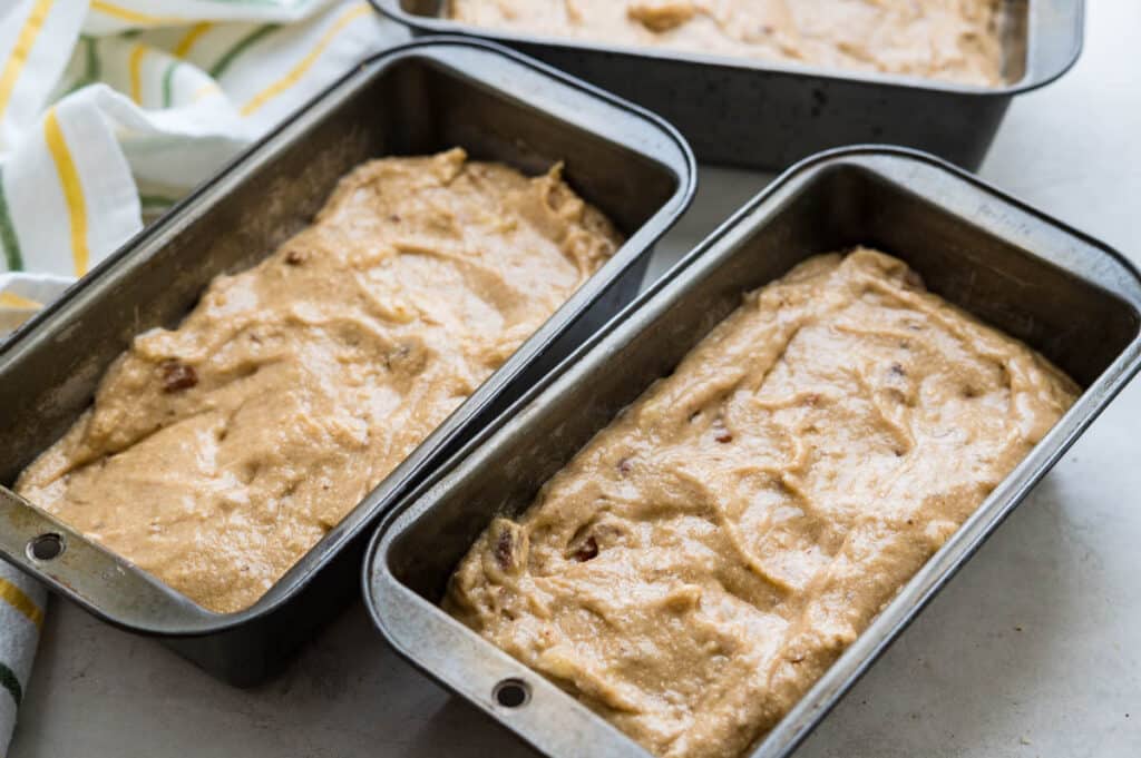 filling bread pans with banana bread batter. 