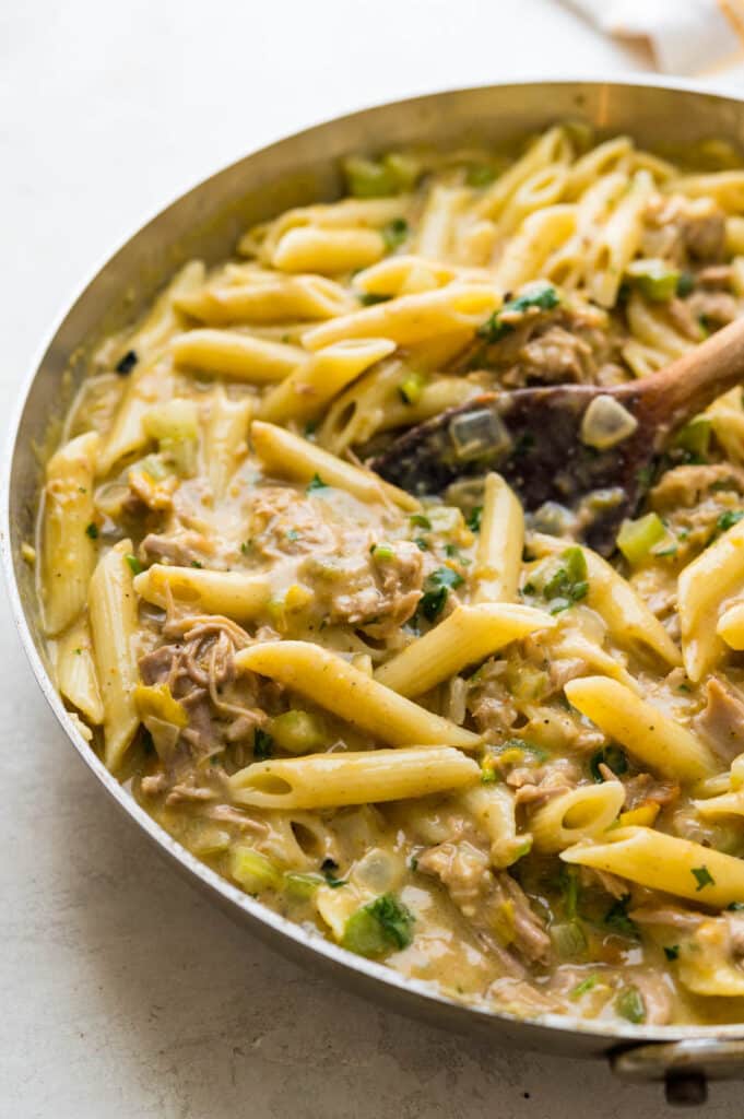 Stir cooked penne pasta into the pulled pork mixture.