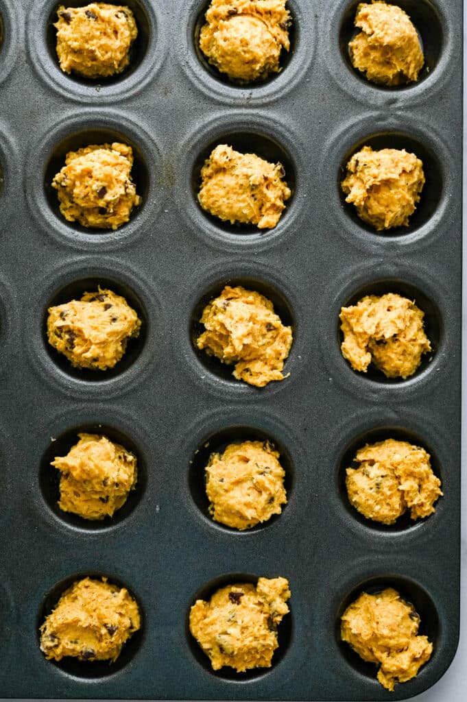 spoon the pumpkin chocolate chip batter into mini muffin tins.
