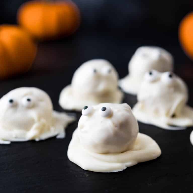 Halloween peanut butter balls decorated like ghosts.
