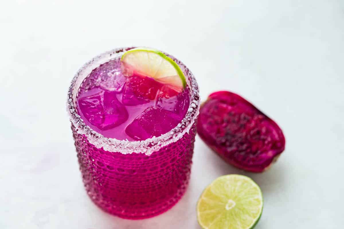 Prickly pear margarita with a lime garnish.