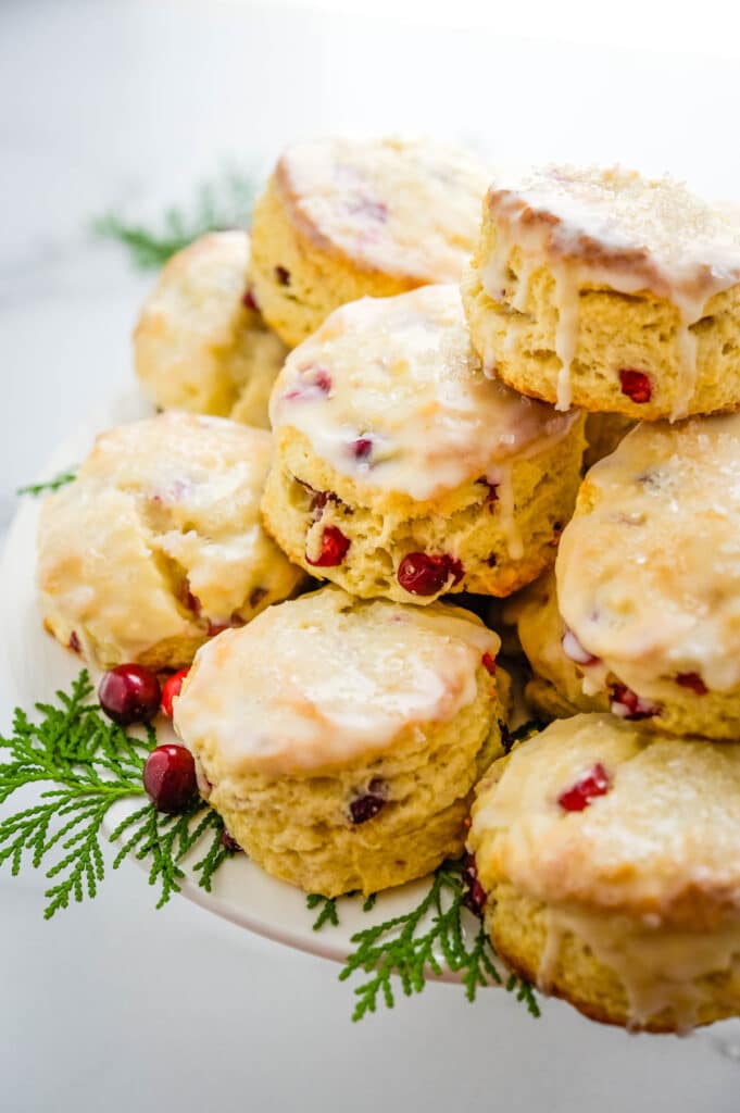 a platter filled with tart lemon cranberry scones with Christmas greenery accents.