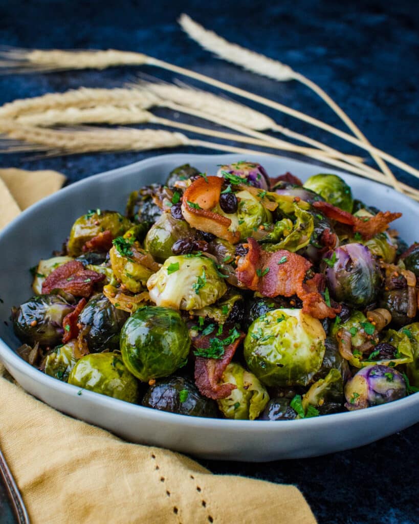 a bowl of dijon glazed brussels sprouts with bacon.