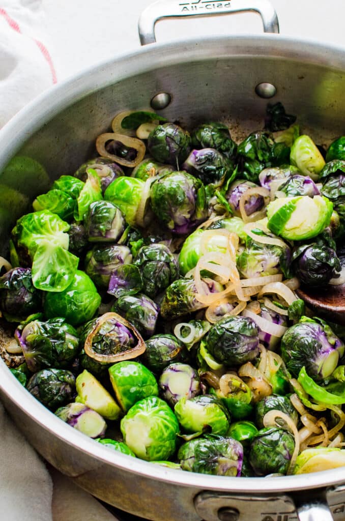adding brussels sprouts to the shallots.