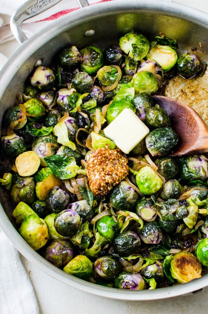 adding mustard and butter to the brussels sprouts.