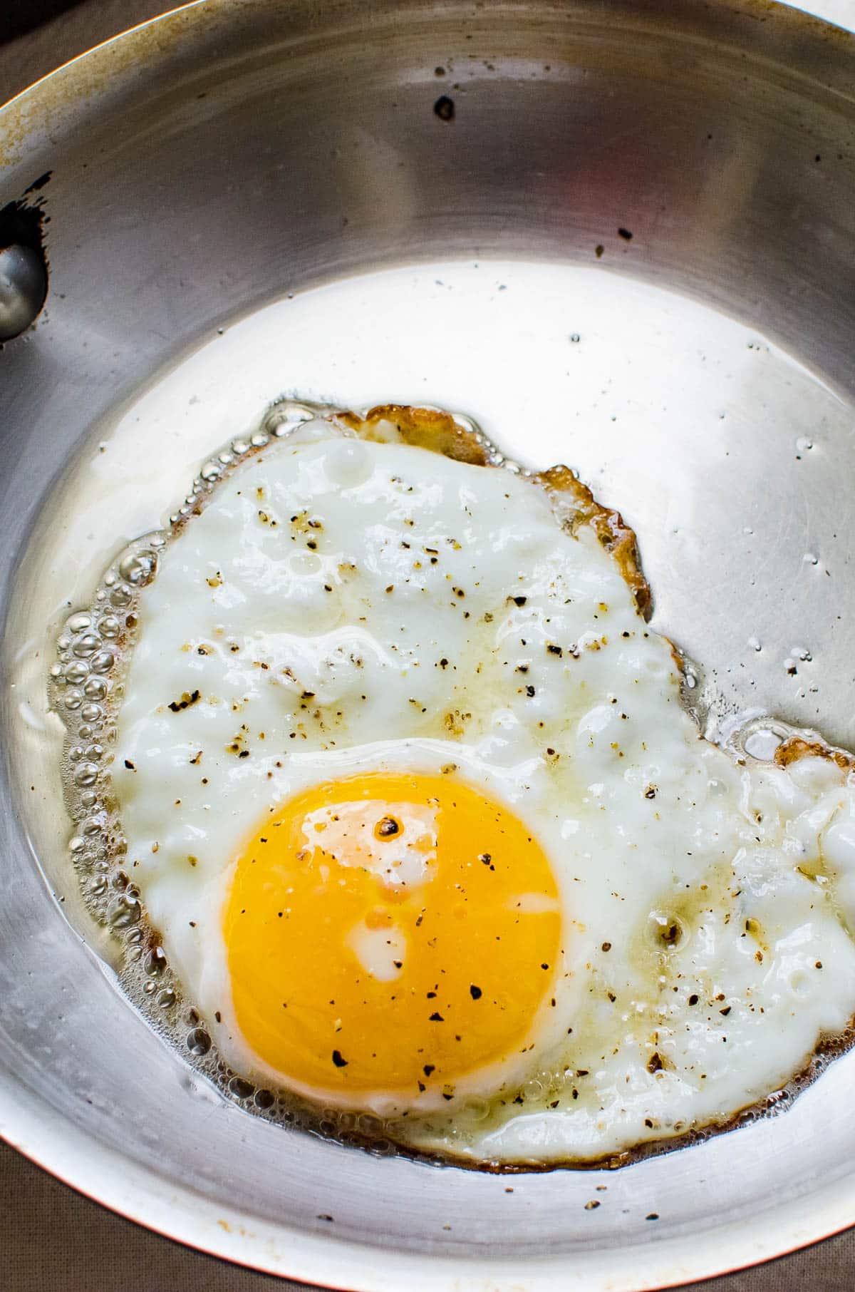 frying an egg in a hot skillet.