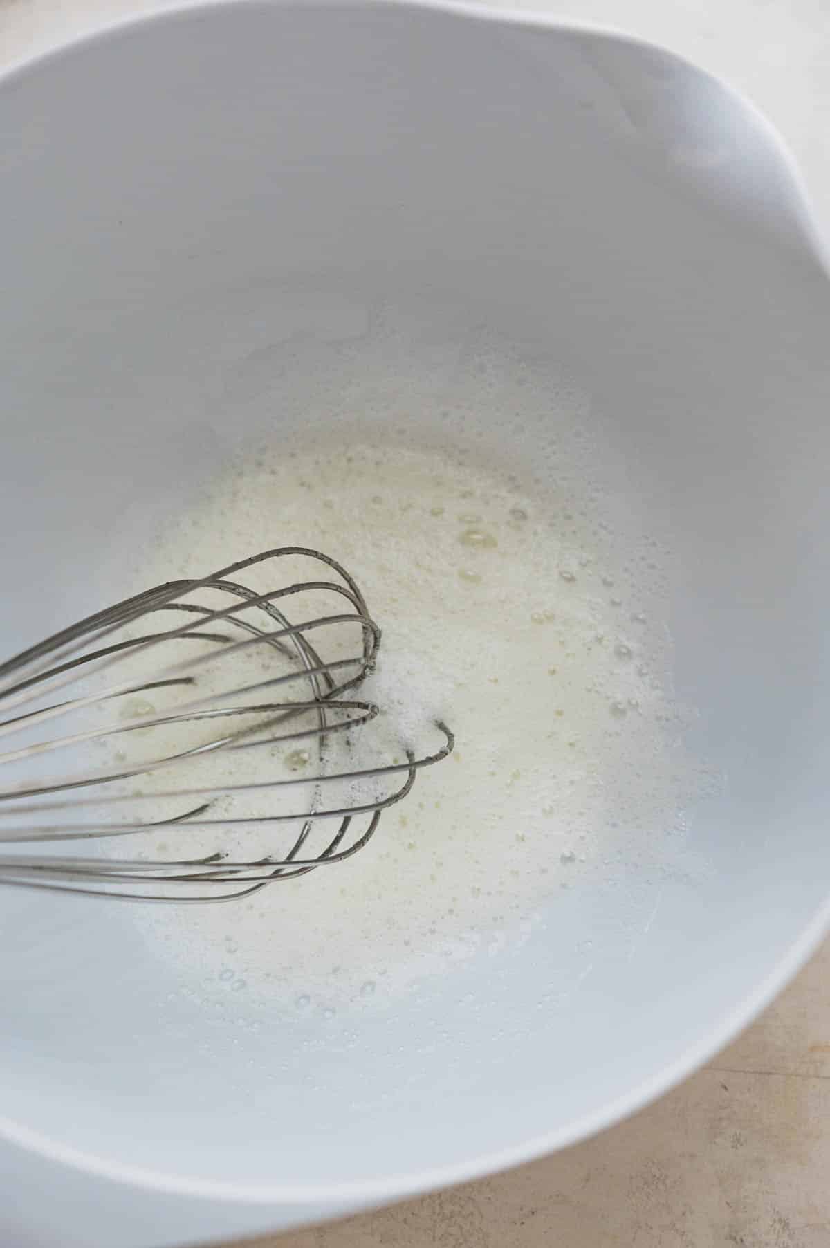 whisking the egg whites into frothy oblivion with a large whisk.
