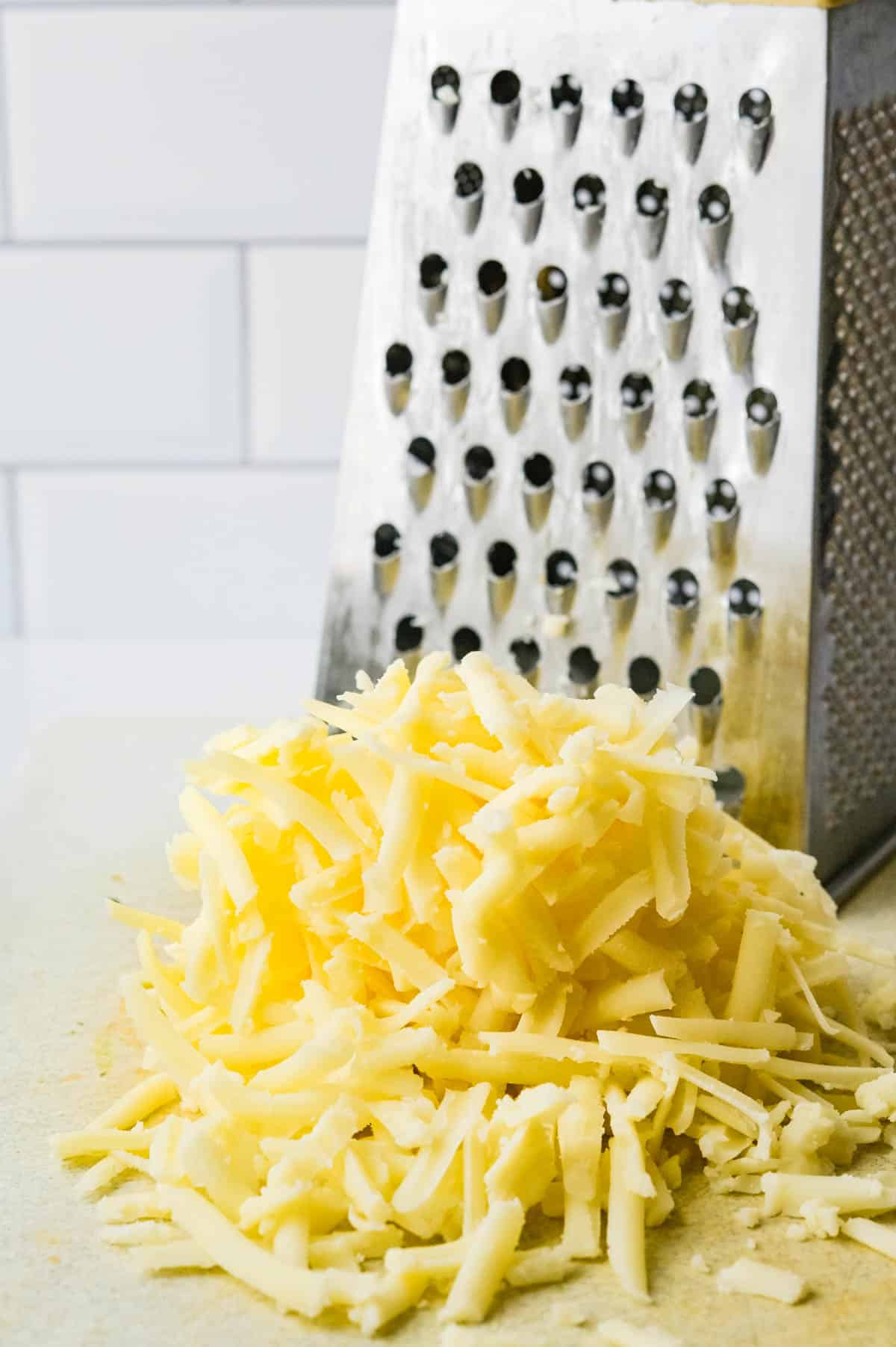 shredding cheddar cheese.
