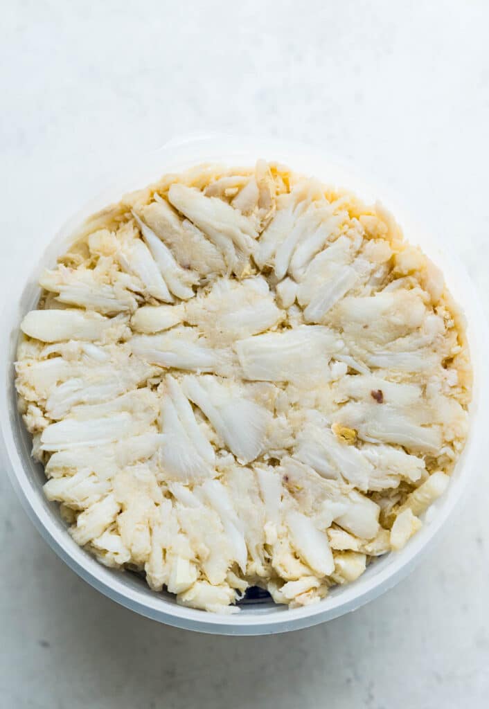 A pound of lump crabmeat in a plastic container.