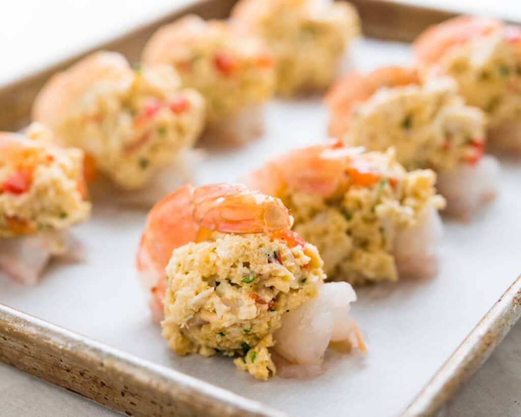 a baking sheet filled with crab stuffed shrimp.