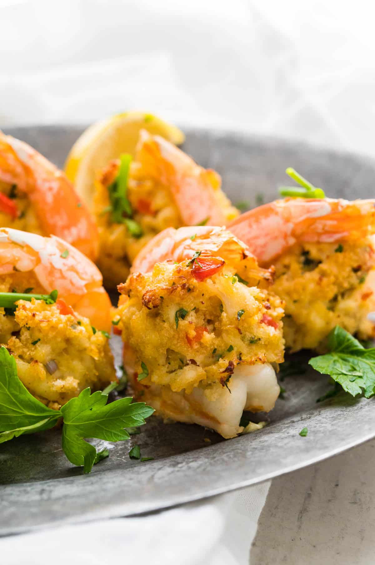 a pewter platter of baked crab stuffed shrimp.