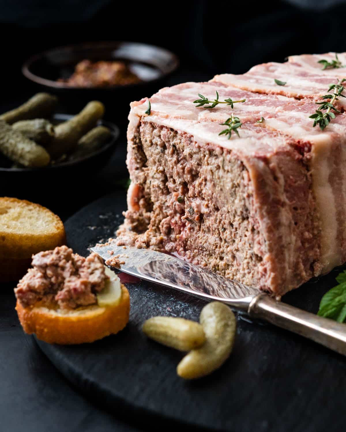Serving the French pate on a board with cornichons.
