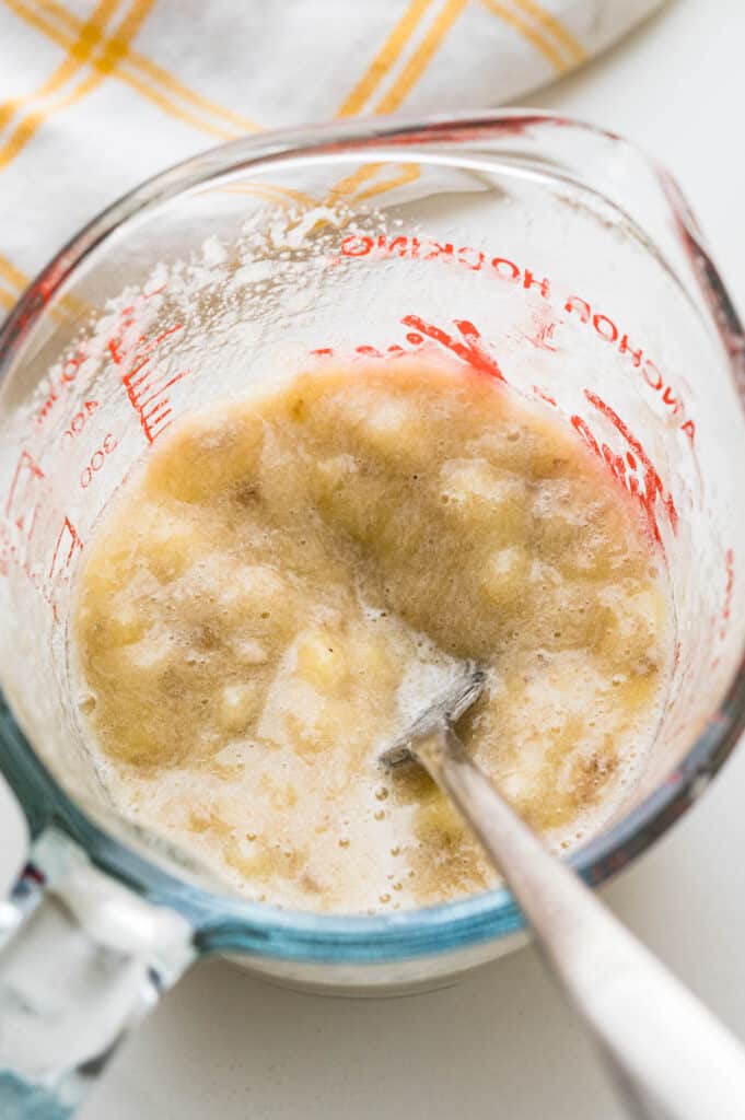 Mash the bananas in a glass measuring cup.