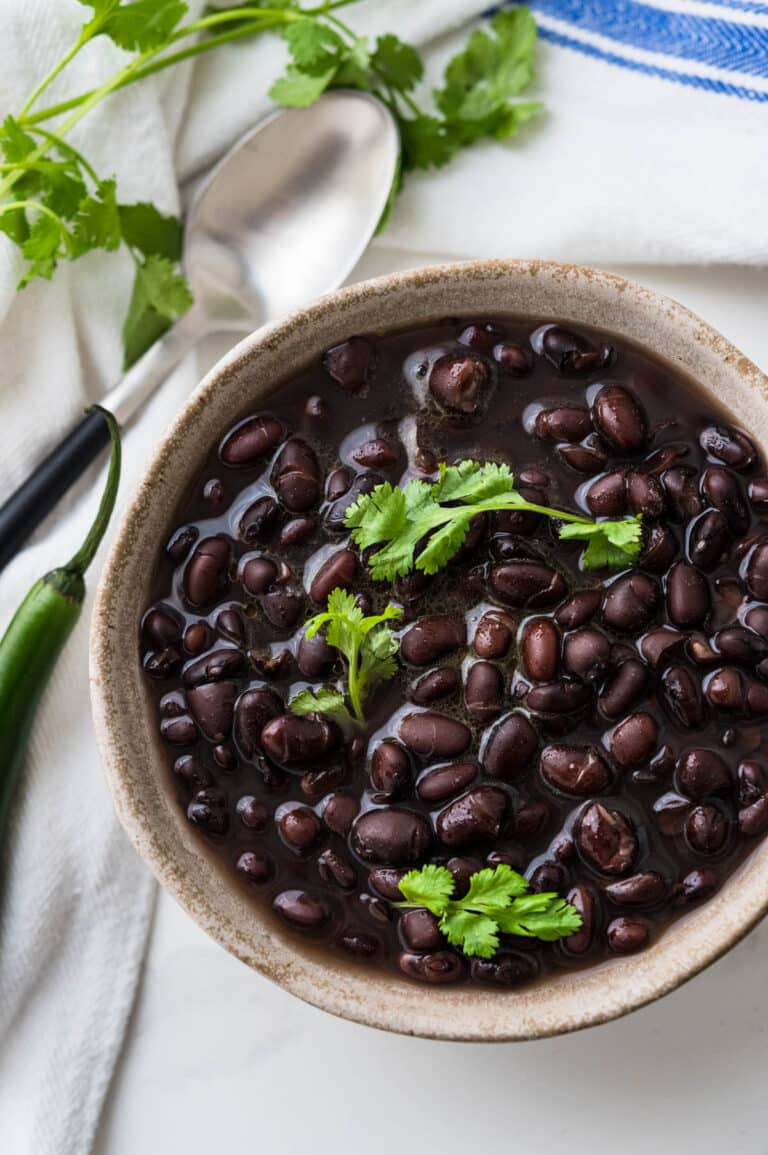 cooked black beans in a bowl with cilantro.