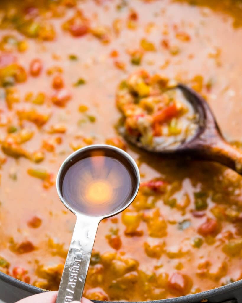 Add sherry for flavoring. This amplifies the flavors of the seafood étouffée.