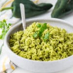 Green rice in a white bowl.