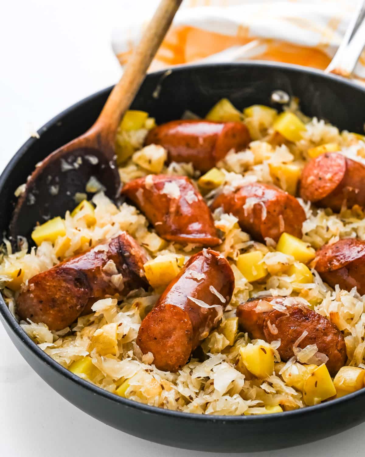 sausage and sauerkraut with potatoes served in a skillet