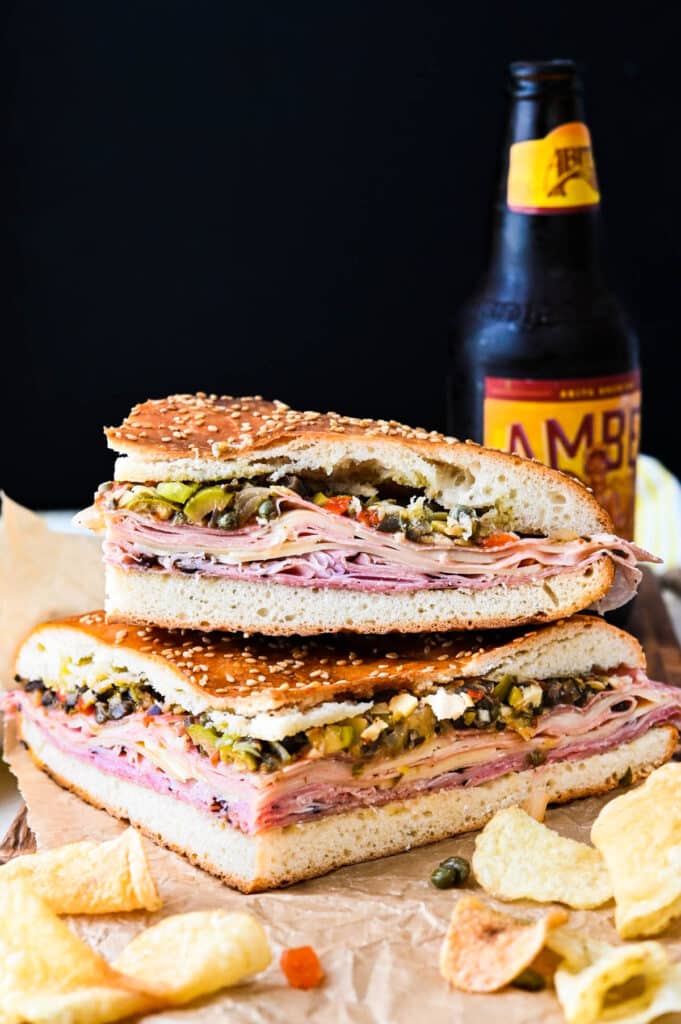 I loaded muffuletta sandwiches with olive salad, tons of ham, cheese and salami on muffuletta bread with chips and a beer.