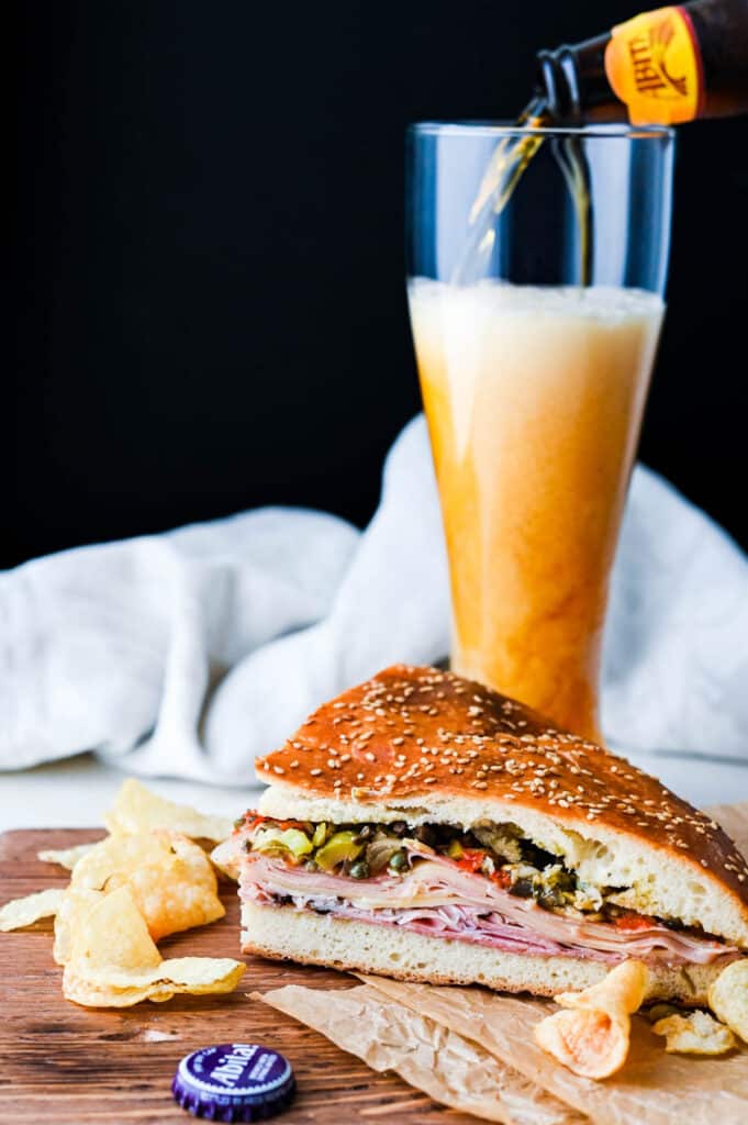 Pouring an abita beer to go with the muffuletta sandwich.