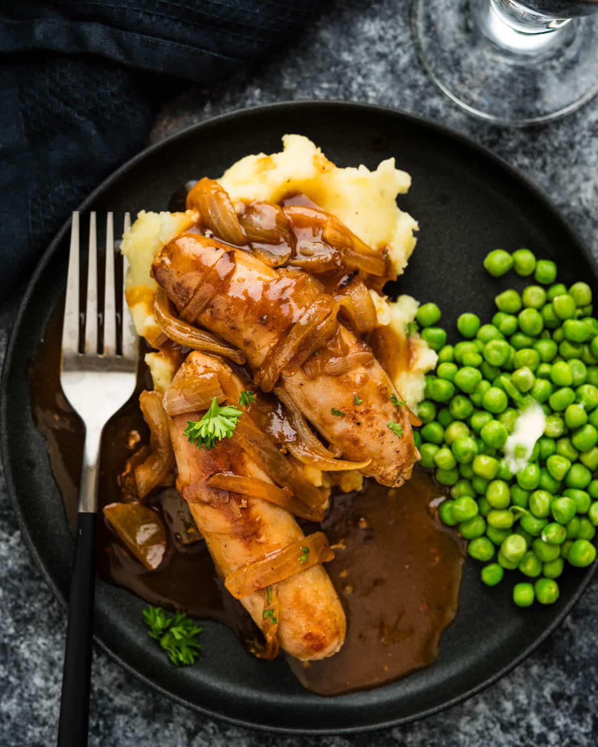 Serving Irish Sausages with onion gravy over mashed potatoes.