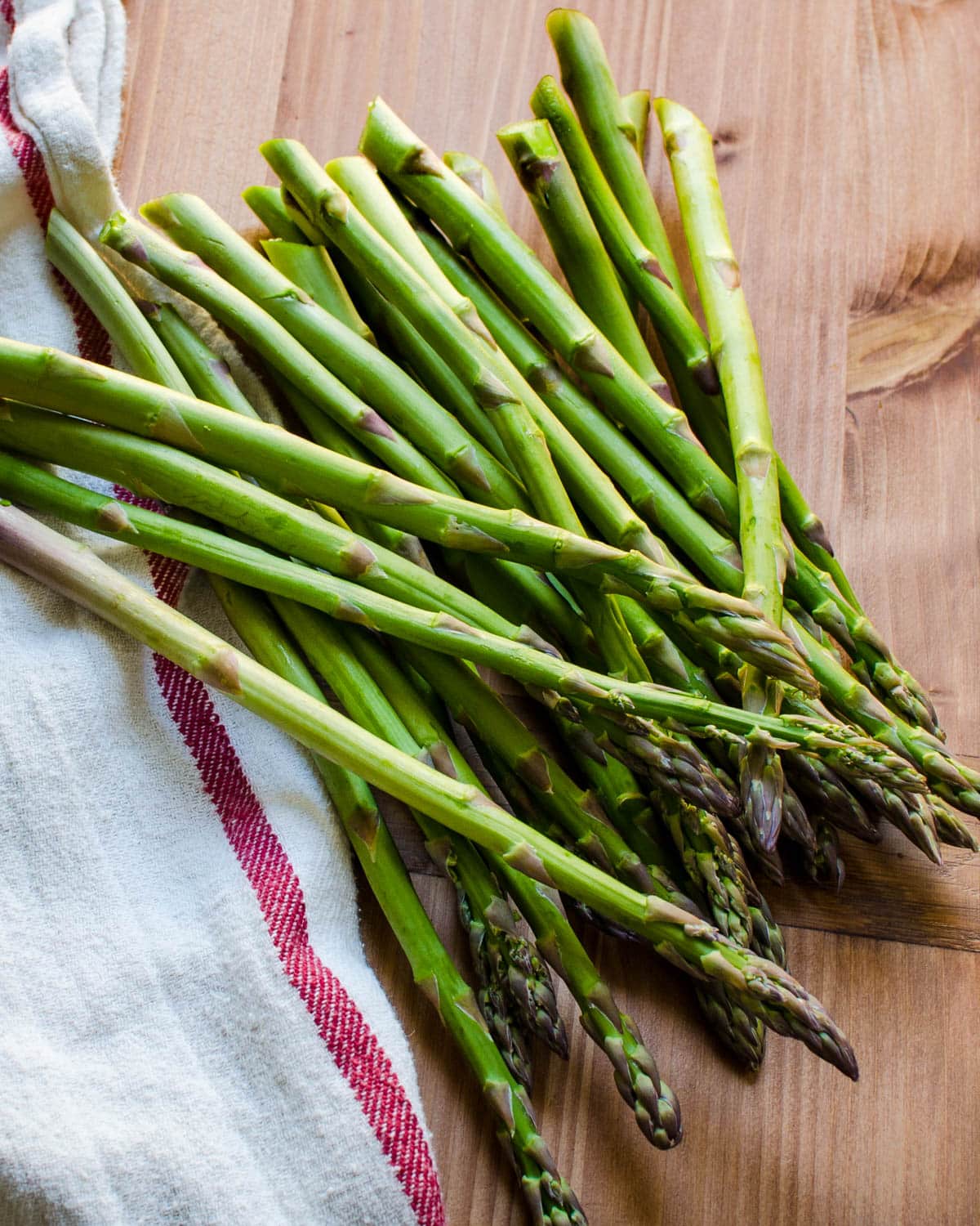 Trim the tough ends of the asparagus while leaving the tips intact.
