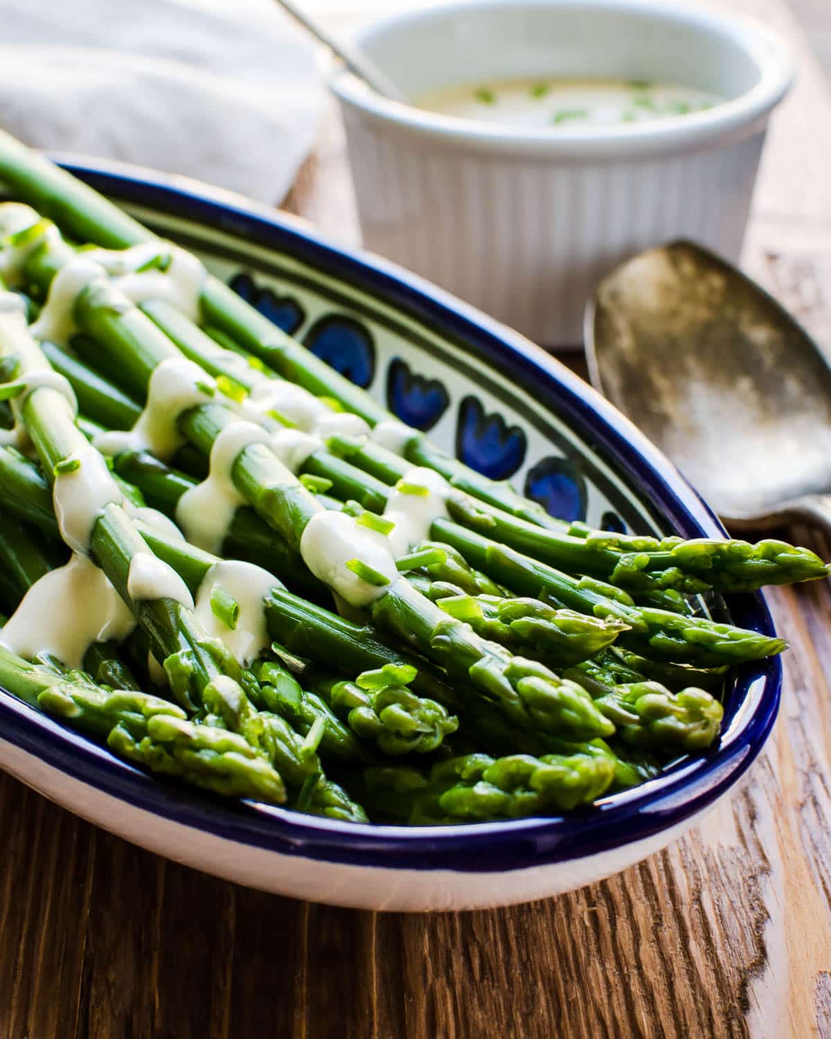 Blanched asparagus with a creamy dijon sauce drizzled over it.