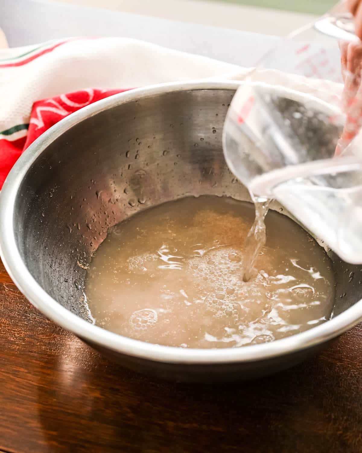 Adding water to the yeast.