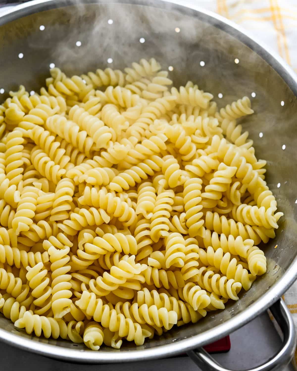 Cooked corkscrew pasta in a colander.