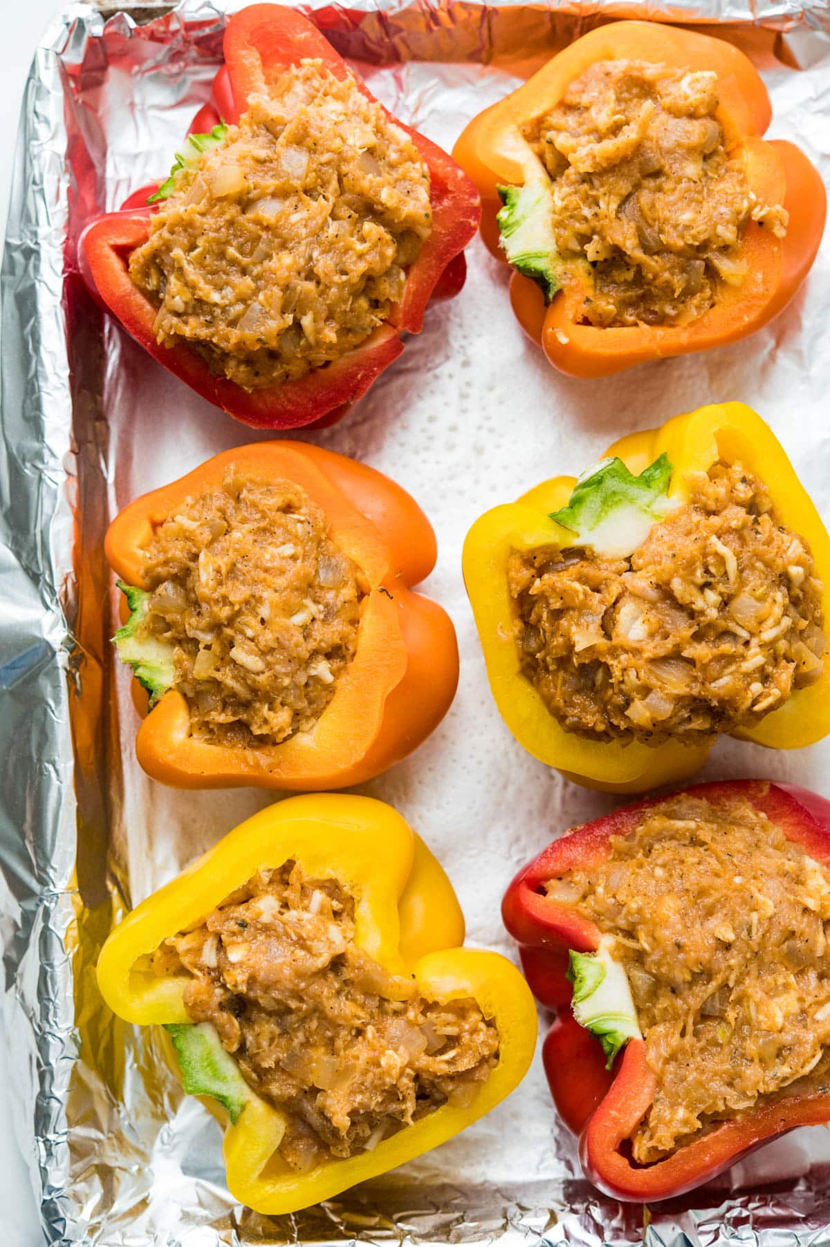 Stuffing the bell peppers with the turkey taco filling.