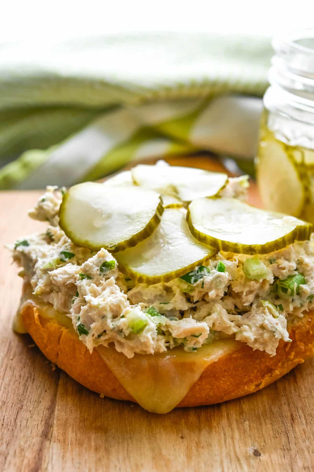 Pile the bottom bun with pepper jack cheese, tuna salad and pickles.