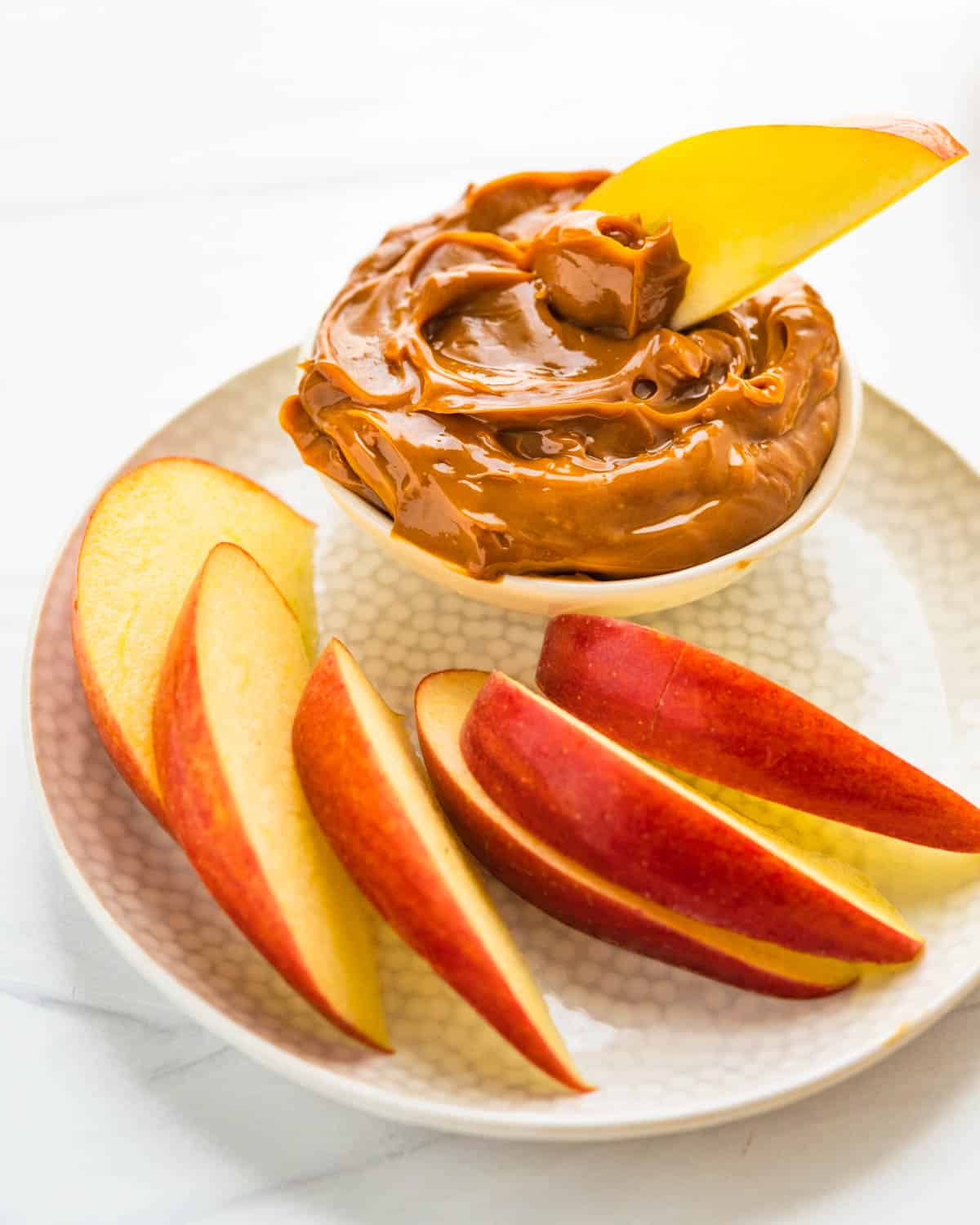 Sliced apples and dulce de leche for dipping.