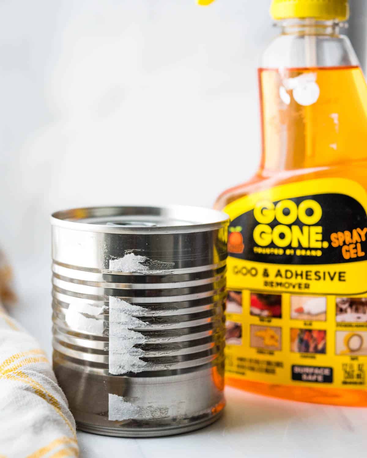 Goo-Gone gets the adhesive off the can so you can cook with it and not ruin your pot.
