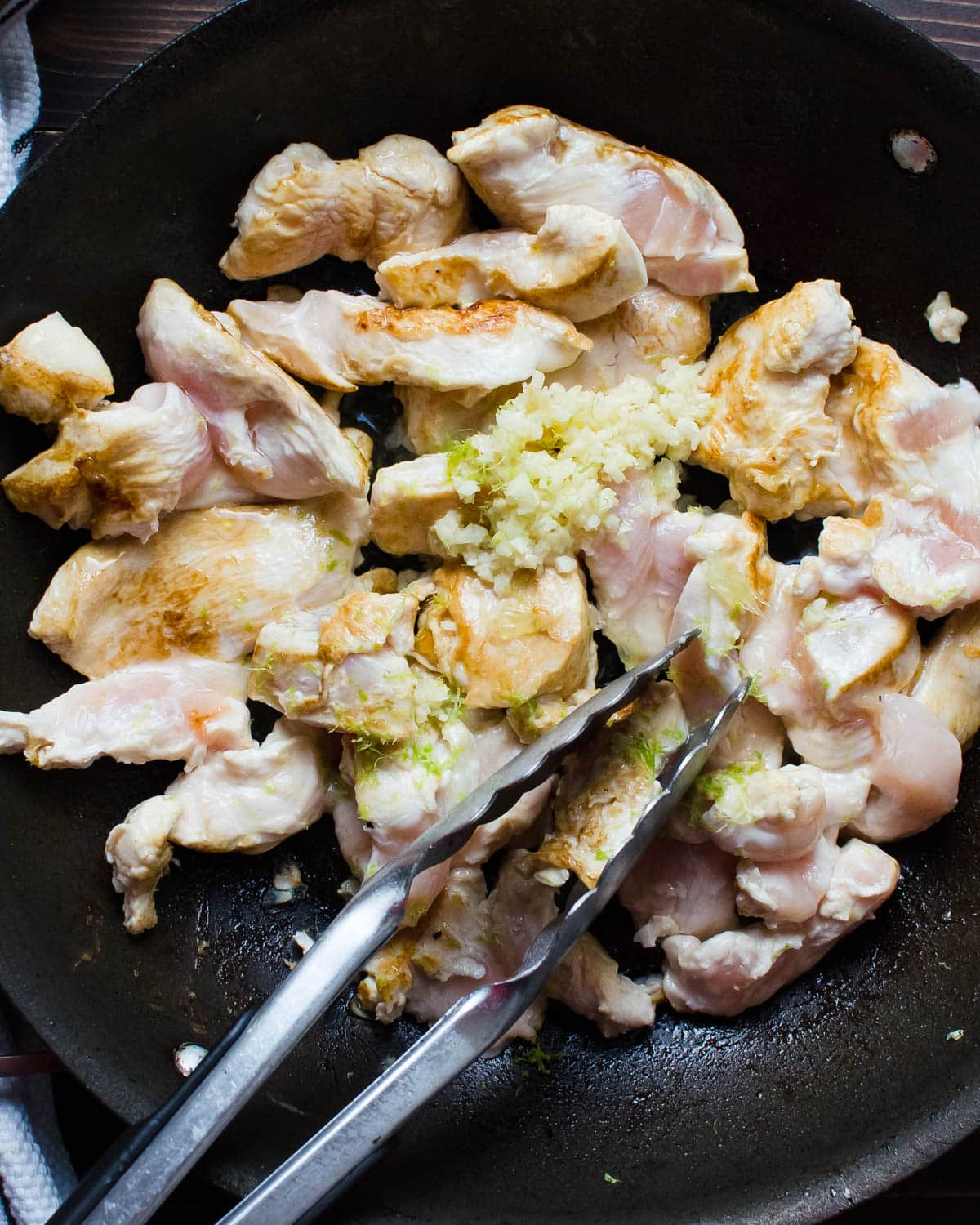 I am cooking sliced chicken breasts with garlic, lime zest and juice in a heavy skillet.