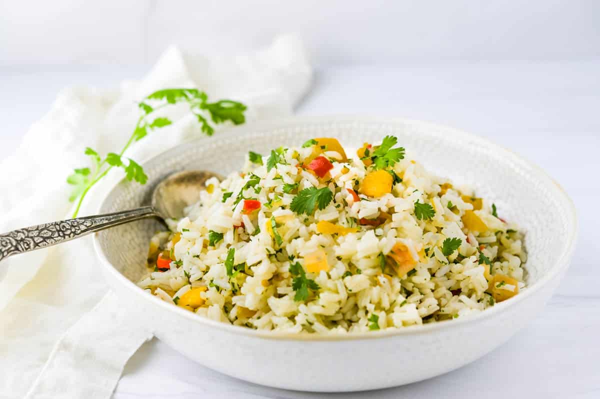 A white bowl filled with pineapple rice.