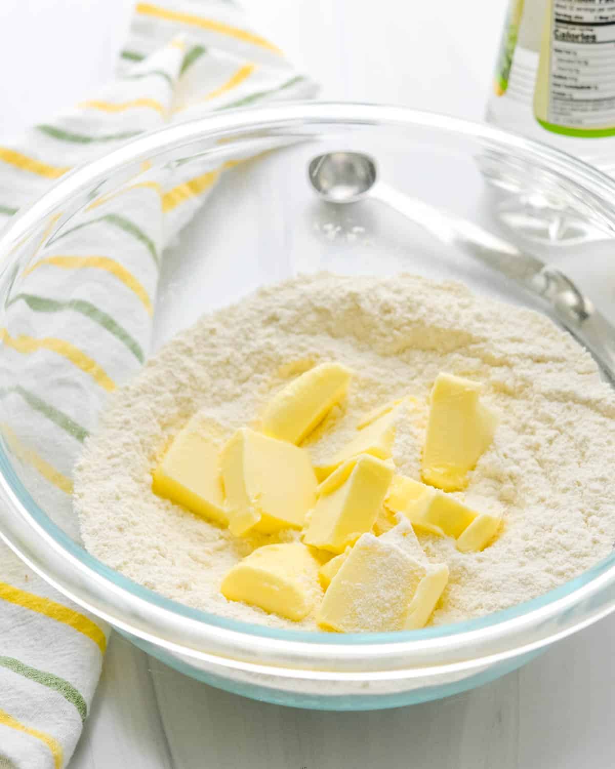 Adding butter to flour mixture.