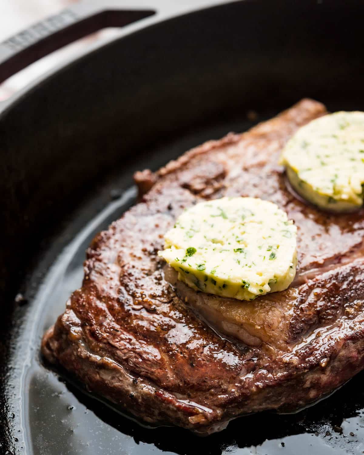 Add pats of the compound butter to the steak.